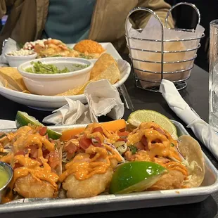 a plate of nachos and a bowl of guacamole