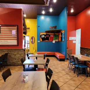 a dining area with tables and chairs