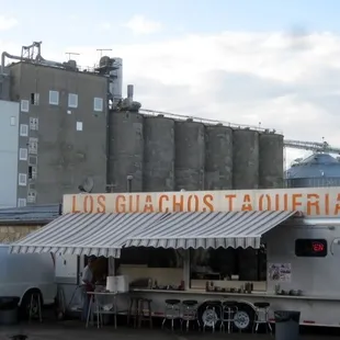 a food truck parked in front of a factory