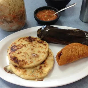 Pupusas revueltas with a tamale and pork empanada.