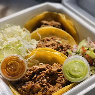 three tacos in a styrofoam container