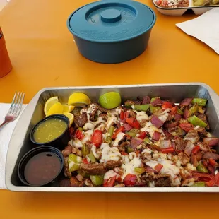 Steak Alambres .. tender cuts of seasoned steak with grilled Onions and Peppers and covered in melted cheese. Served w/ 2 salsas.
