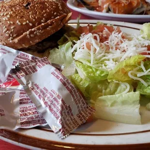 a plate of food with a sandwich and salad