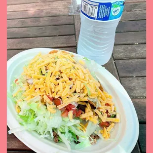Two crunchy steak tacos; bottle water