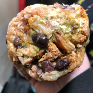 a hand holding a burrito