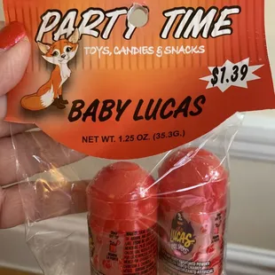 a person holding a party time candy