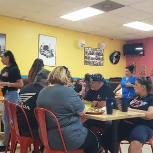 a group of people sitting at a table in a restaurant