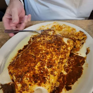 This is the biggest chicken burrito. Covered in red sauce and queso cheese