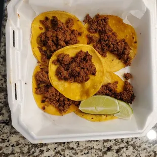 three tacos in a styrofoam container