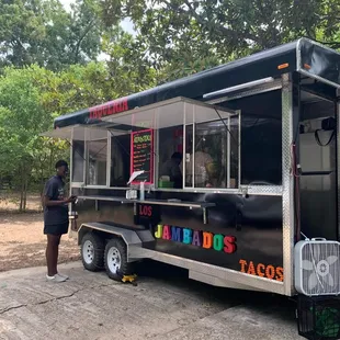 a man standing in front of a food truck