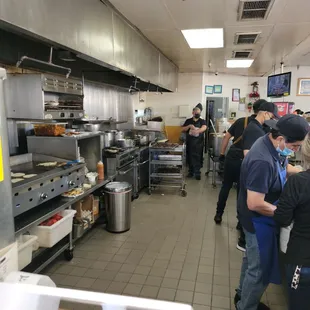 Saturday morning rush and the staff is like a well oiled machine. Those are fresh roasted chiles on the trays... no canned stuff.