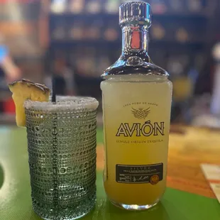 a bottle of avion next to a shot glass