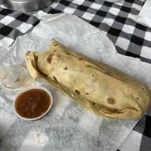 Asada breakfast burrito with salsa on the side