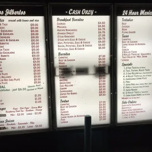Menu of drive through window at night.