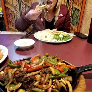 a woman eating a plate of food