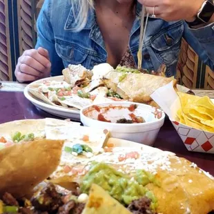 a woman eating a plate of nachos