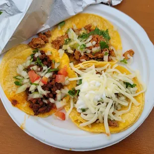 two tacos on a paper plate