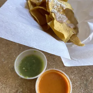 Chips and hot sauce before my meal came out. The orange sauce has lots of heat