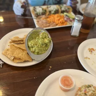 Guacamole &amp; chips  Steak tacos in the background