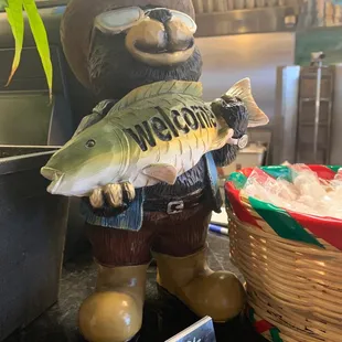 a statue of a bear holding a fish