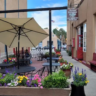 a patio with tables and chairs