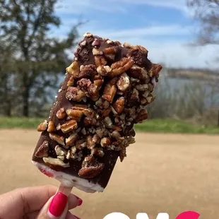Cream and strawberries covered with chocolate and pecans.