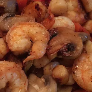 Fajitas del mar - shrimp and scallop fajitas with tortilla, refried bean, guac, lettuce, sour cream, and tomato on the side