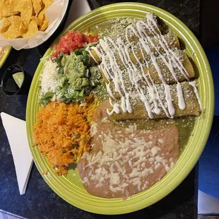 Verde Chicken enchiladas with rice and beans.