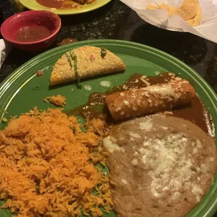 Combo plate with a taco and an enchilada and rice and beans