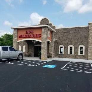 a truck parked in front of a restaurant