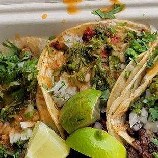 three tacos in a styrofoam container