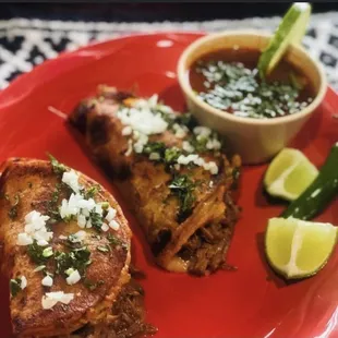 Quésibirria, Two tacos size corn tortilla quesadillas with cheese and Birria meat, consomé broth on the side.