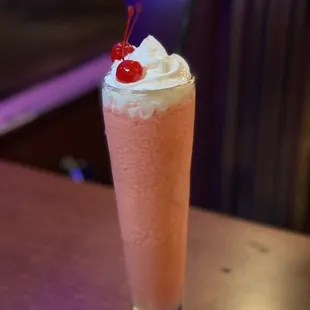 a drink with whipped cream and a cherry on top
