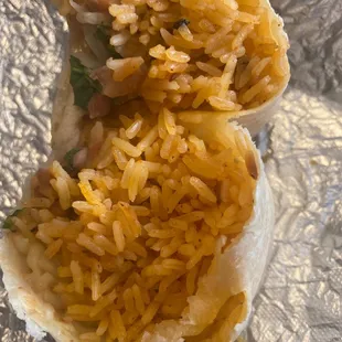 a burrito with rice and beans