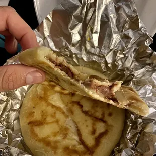 a person holding a piece of food