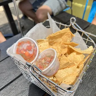 a basket of chips and salsa