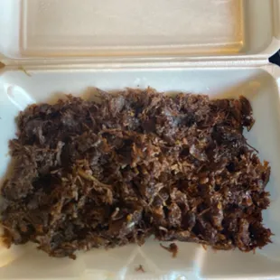 shredded beef in a styrofoam container