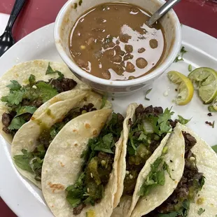 a plate of tacos and a bowl of salsa