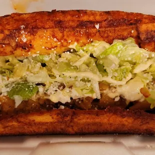 a hot dog in a styrofoam container