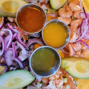 Maricada. An appetizer  of fish ceviche, shrimp ceviche, octopus, avocado, onion, aguachile salsa come with three different sauces.