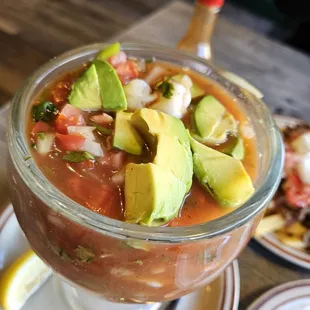 a bowl of soup with avocado