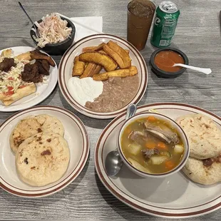 Yuca con Chicharon, Platanos Fritos, Pupusas con Queso y Loroco and a bowl of Sopa de Res.