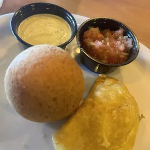 Buñuelo and beef empanada with their house sauce (great) and their odd ají, that has too much tomatoes in it.