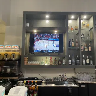 a bar with a television and liquor