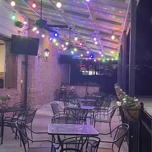 a patio with tables and chairs