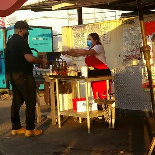 a man and woman preparing food