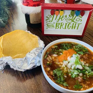a bowl of soup and a tortilla