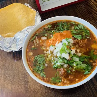 a bowl of soup and a tortilla