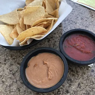 a bowl of chips and a bowl of salsa