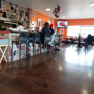 Bar area. Most indoor tables seat 4,  easy to move to sear more. Covered patio, w Tables, Lights. Happy Hour shade 3-6.